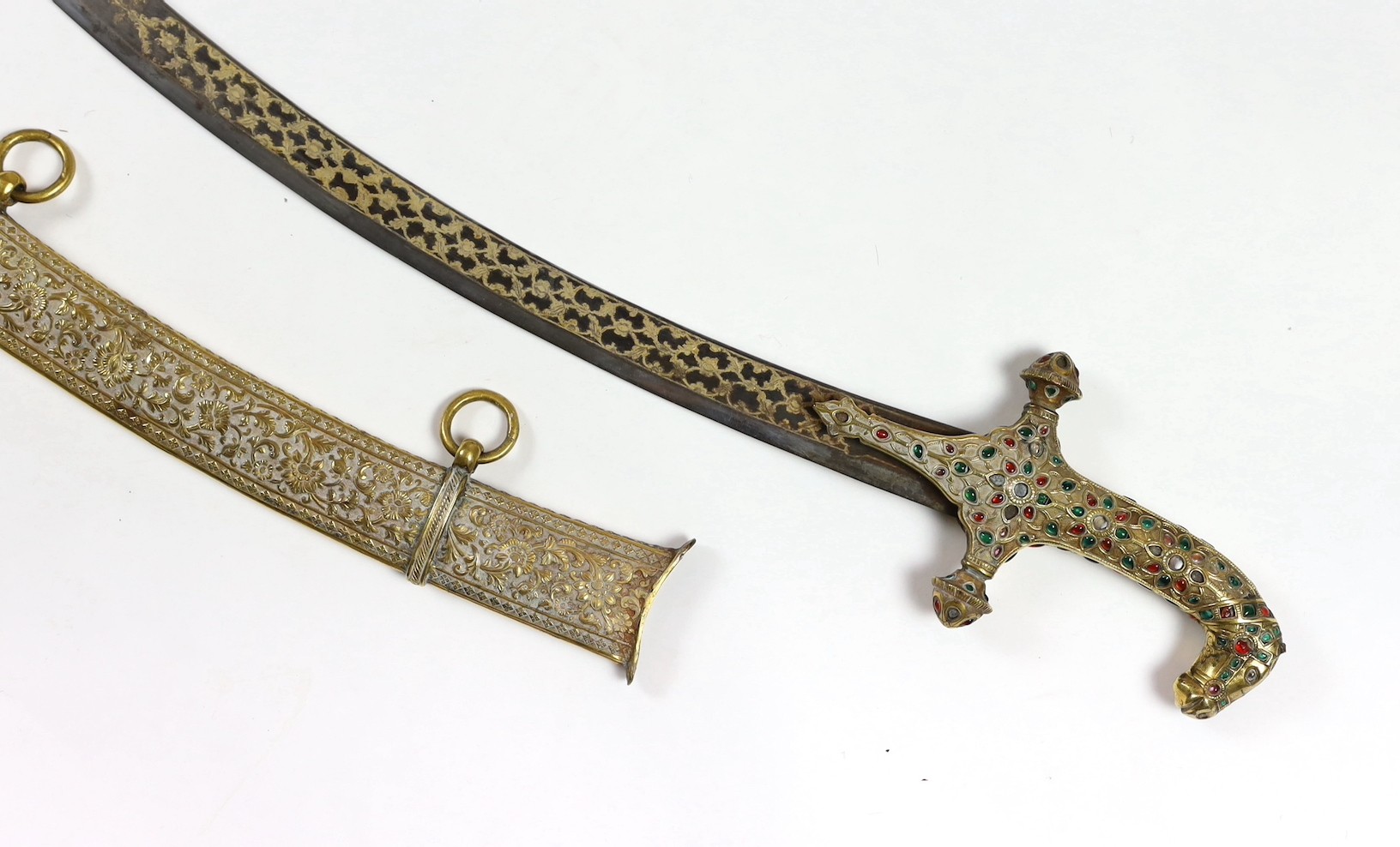 A fine Indian gilt copper and paste mounted sword (shamshir), Kutch, 19th century, sword 79cm long, scabbard 75cm long